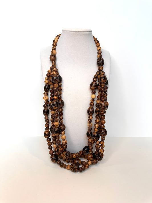 Long brown beaded necklace made of acai and paxiuba seeds