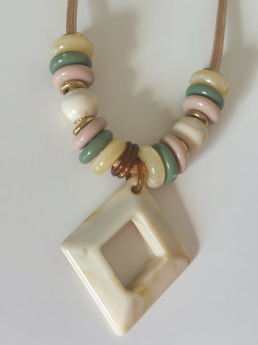 Close-up Edge Line Necklace featuring rope cord, geometric resin pendant, and multicolor beads from the Echoes of Brazil collection.