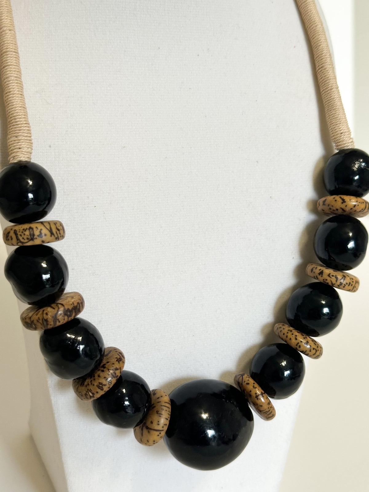 Close-up of jarina vegetable ivory beads with paxiúba and jupati seeds in handmade Amazon necklace.