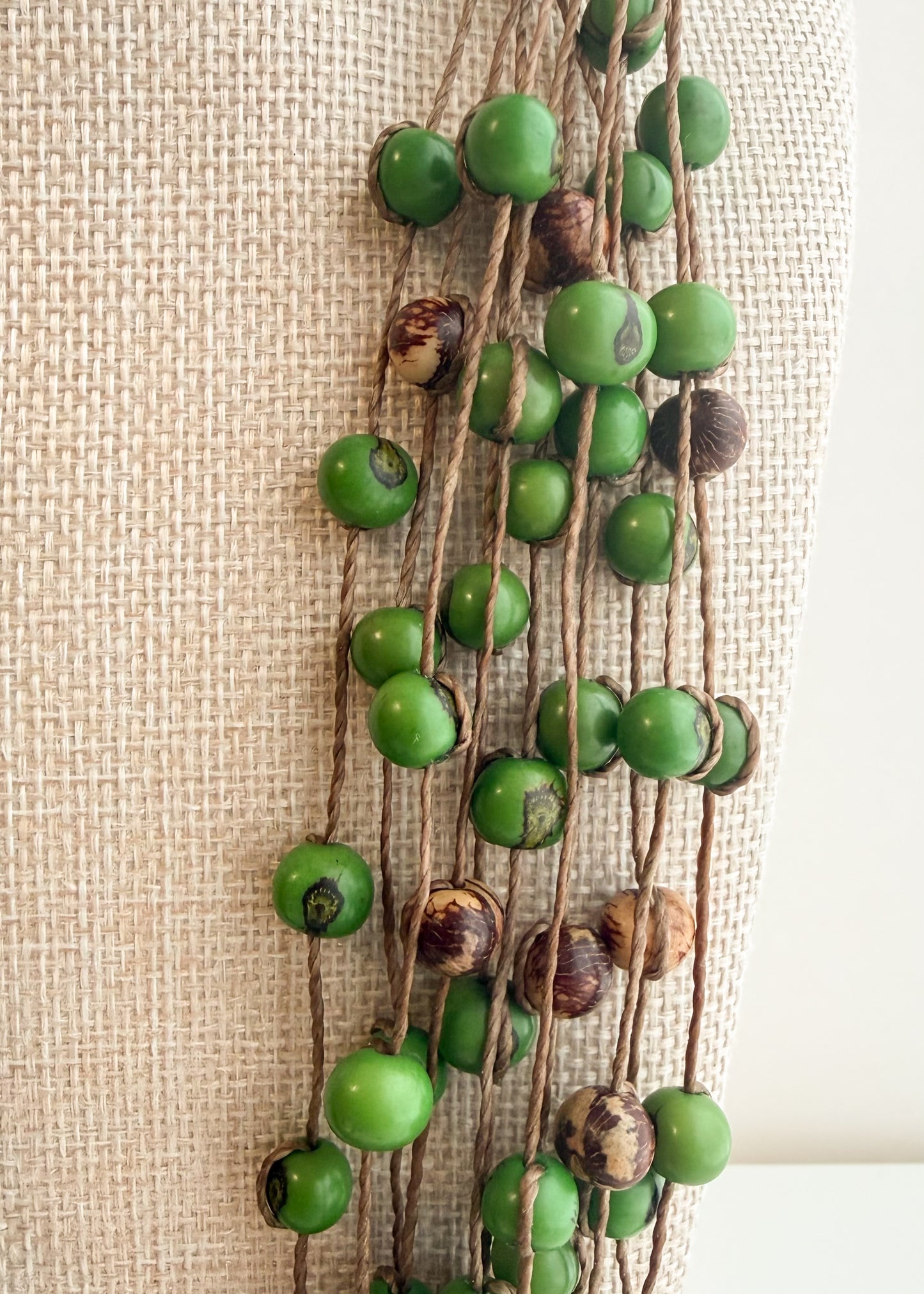 Close-up of multi-strand green Açaí seed necklace handcrafted in Brazil
