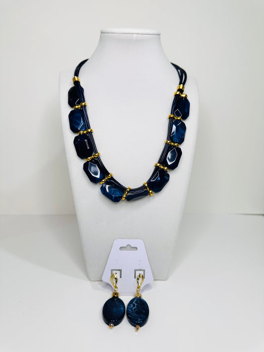 Blue Necklace and earrings set on a white mannequin bust with a white background