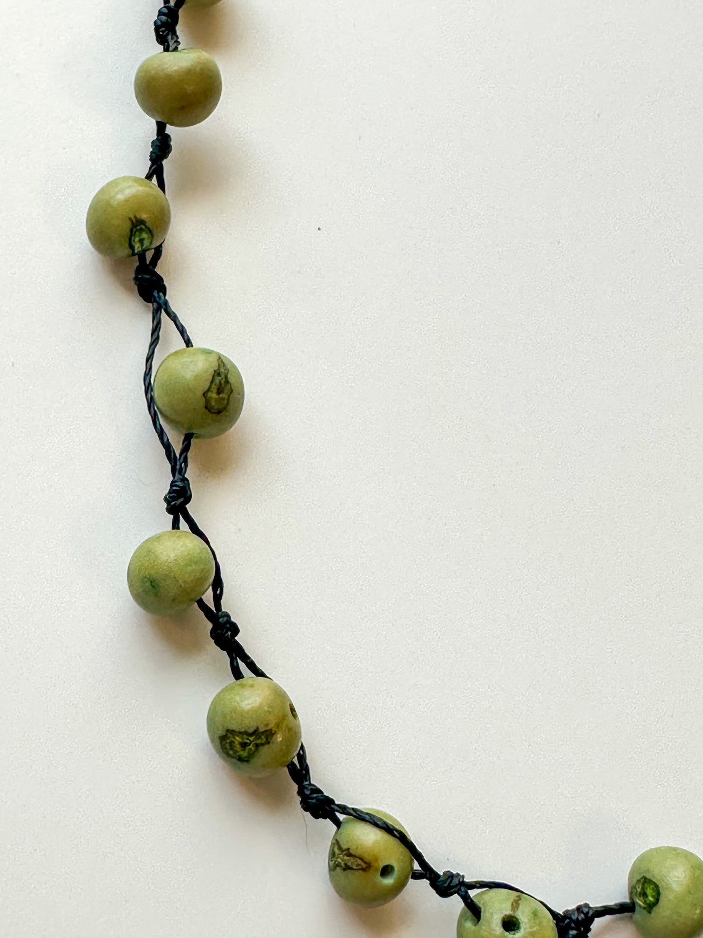 Green dyed açaí seed necklace handcrafted by Indigenous artisans.