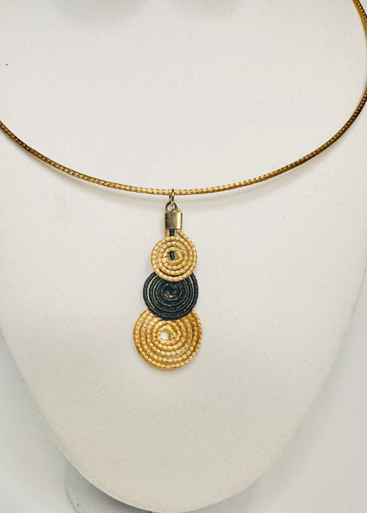 Handwoven golden grass pendant with contrasting detail