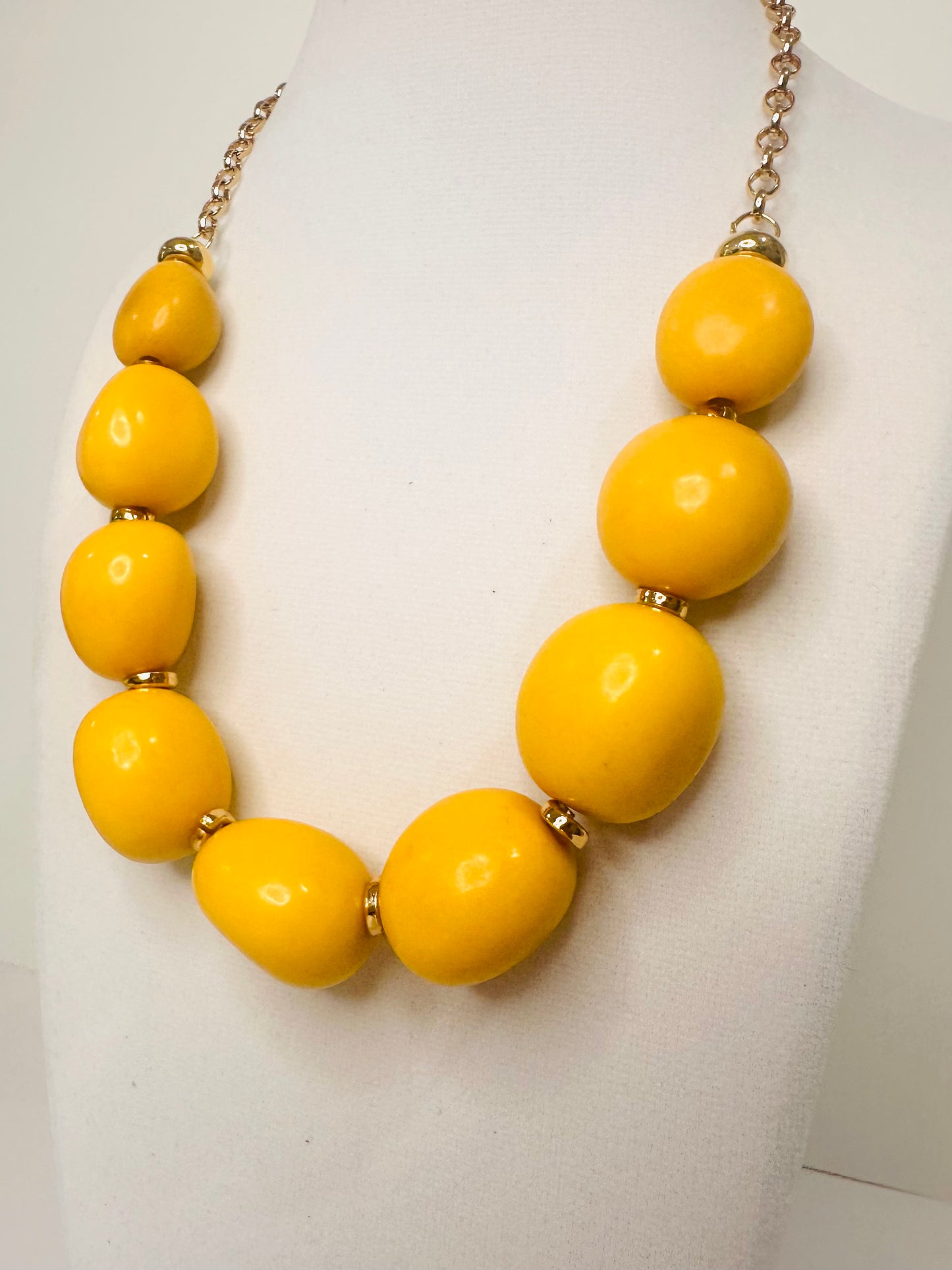 Yellow beaded necklace on a white background