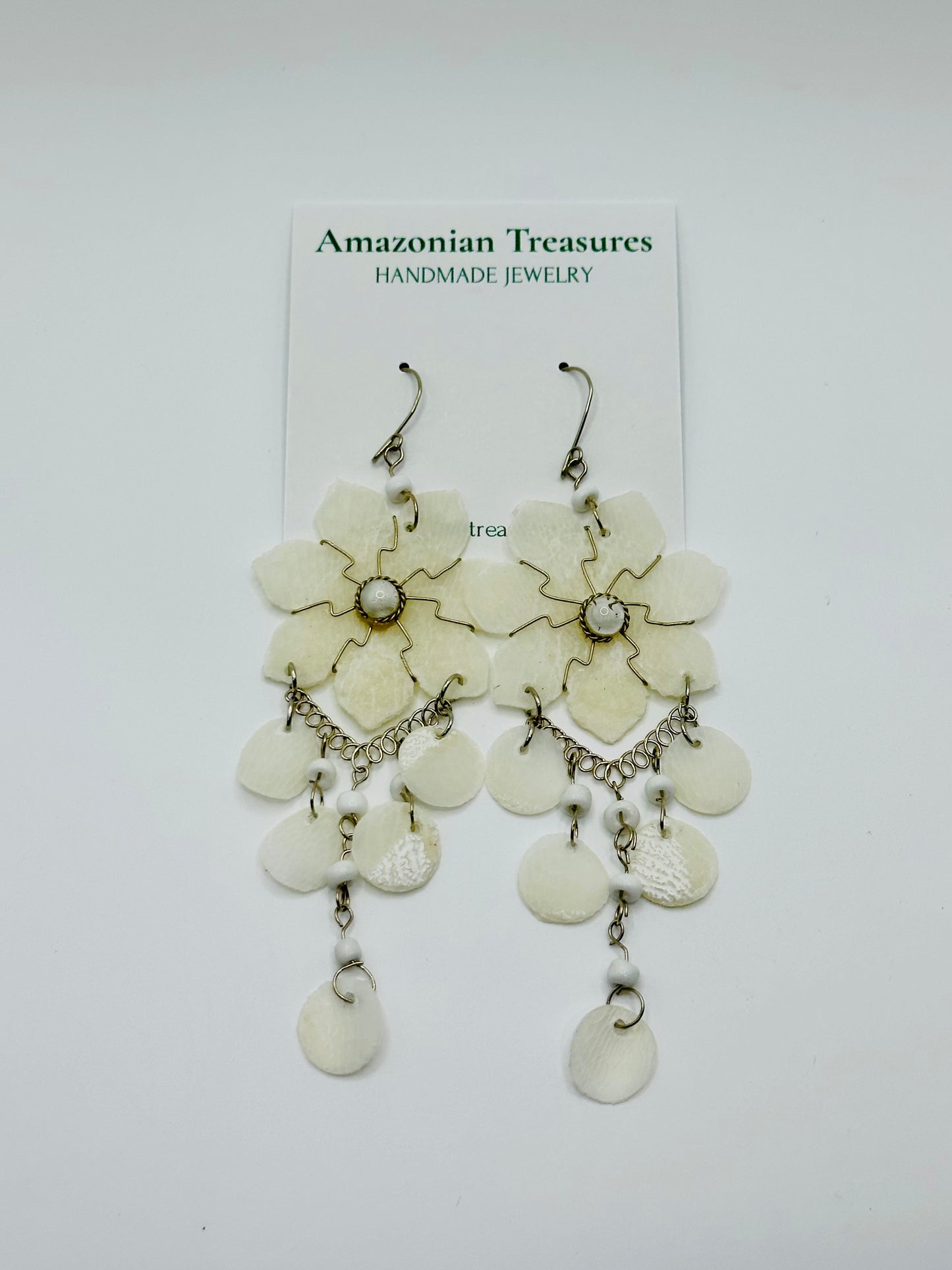Pirarucu fish scale earrings handcrafted by riverside artisans in the Brazilian Amazon