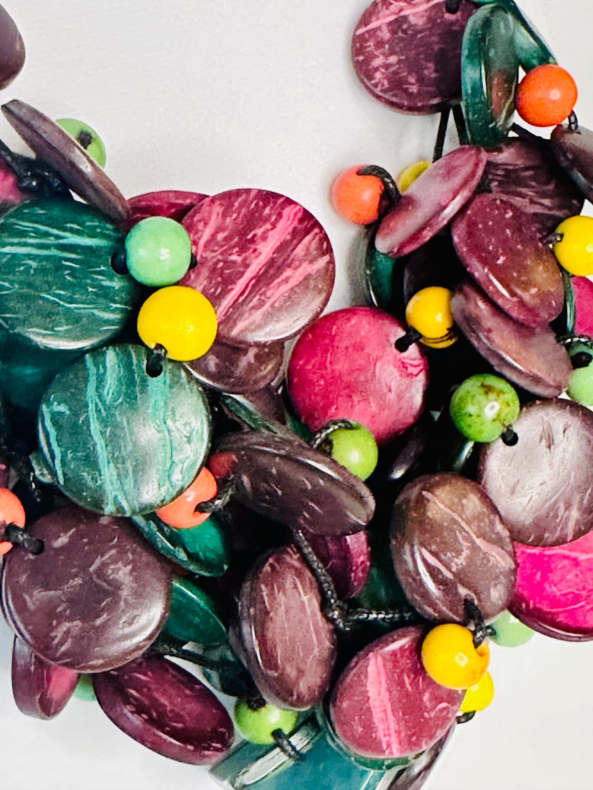 Polished Amazon açaí beads and natural fiber texture