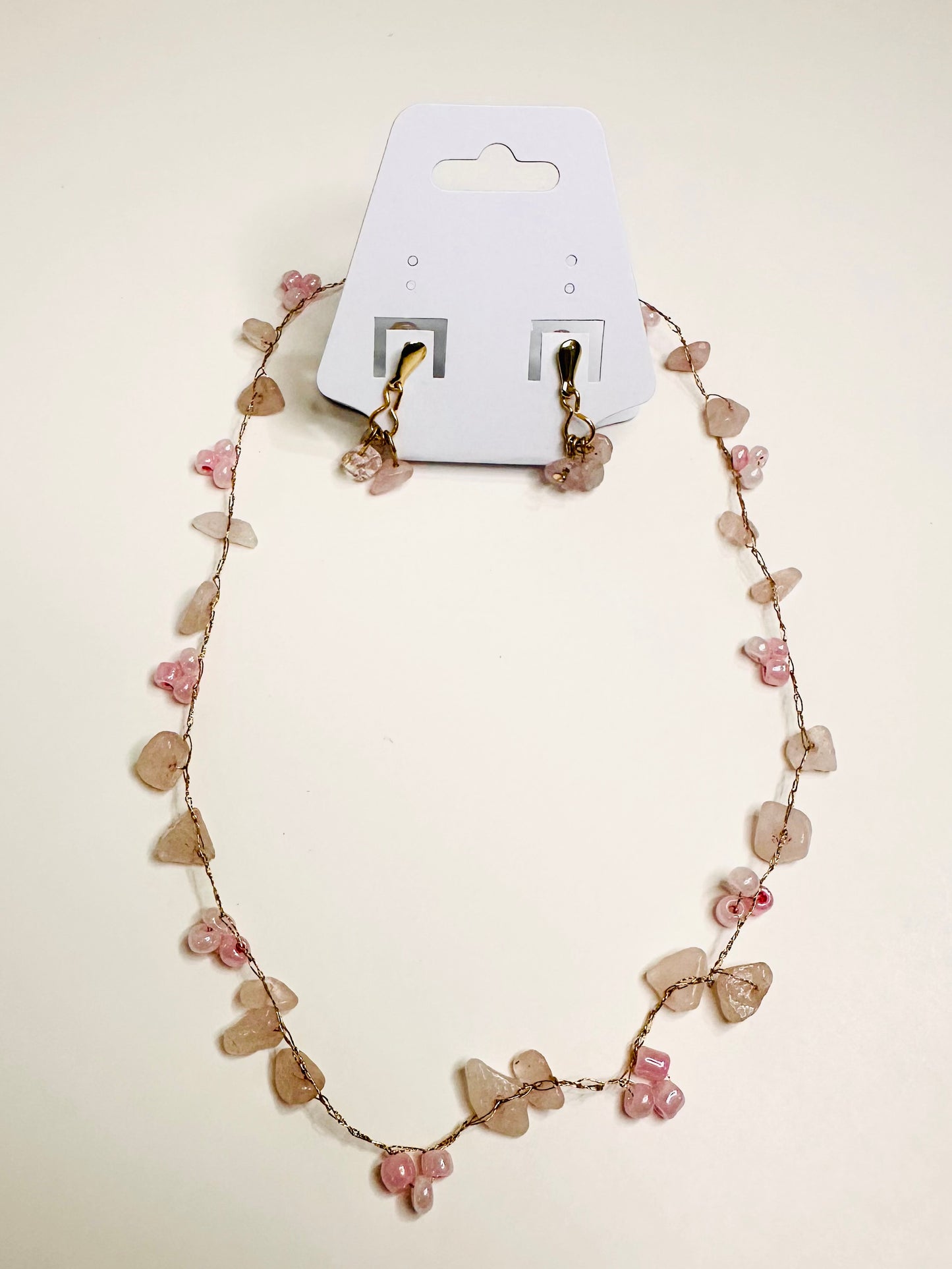 Necklace with light pink stones on a white background