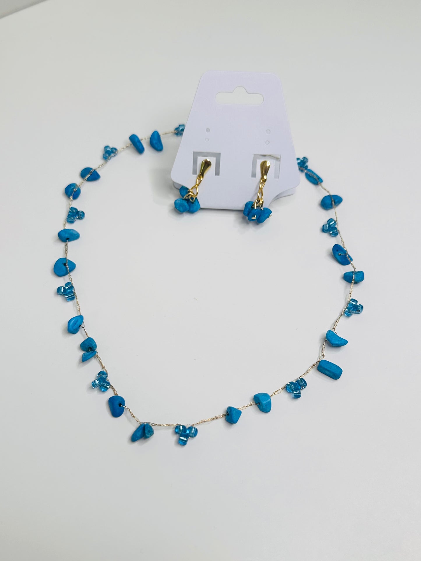 Blue beaded necklace and earrings on gold thread