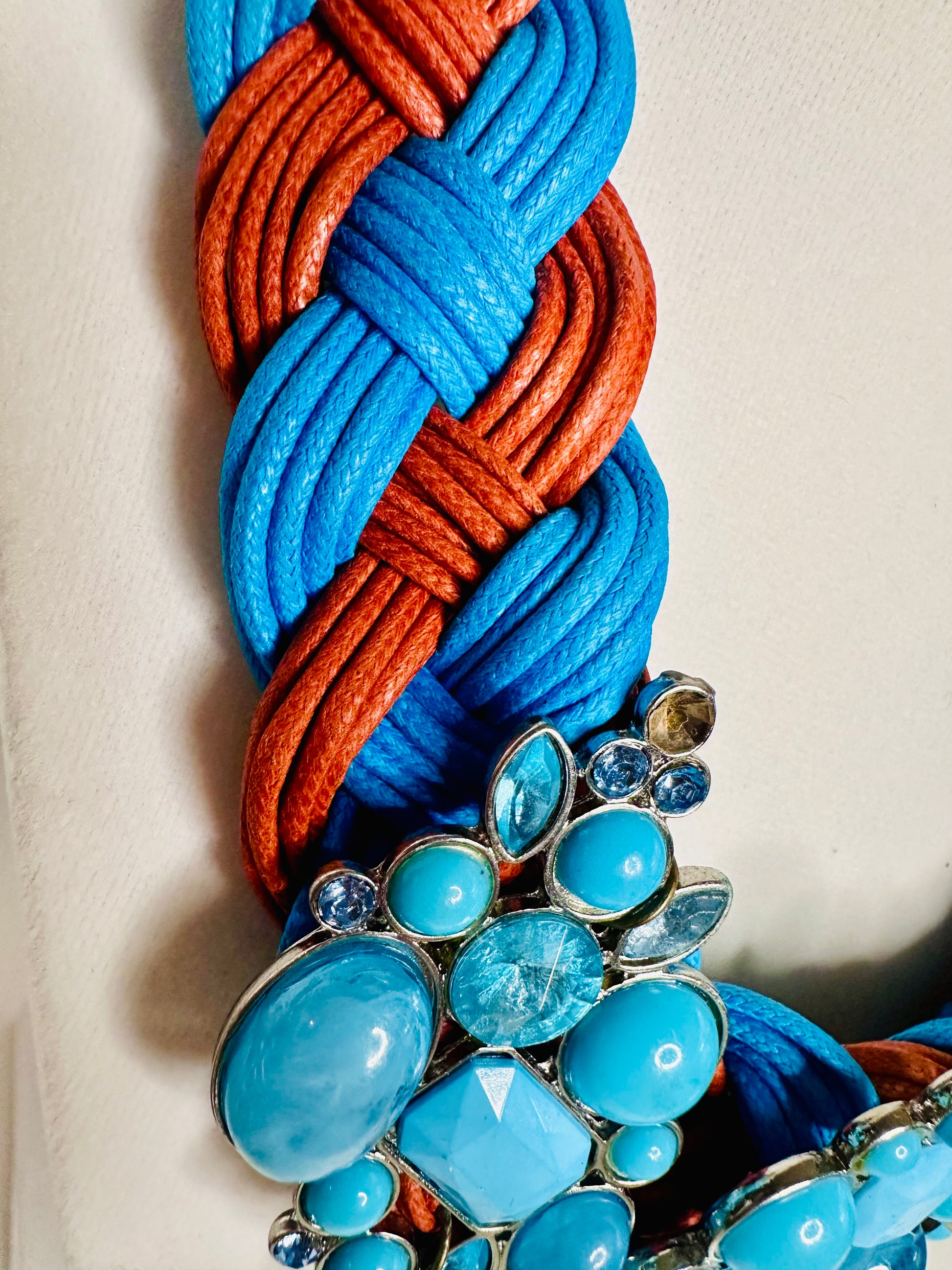 Azul Fogo braided cotton statement necklace featuring blue and orange twisted strands with layered turquoise-tone bead detail.