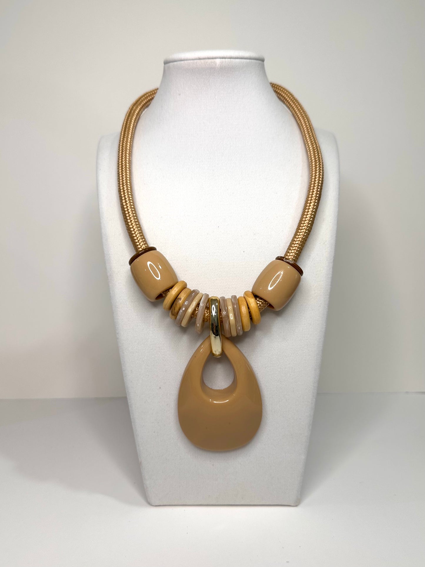 Beige Urban Flow resin necklace set featuring oversized circular pendant on rope cord with matching statement earrings.