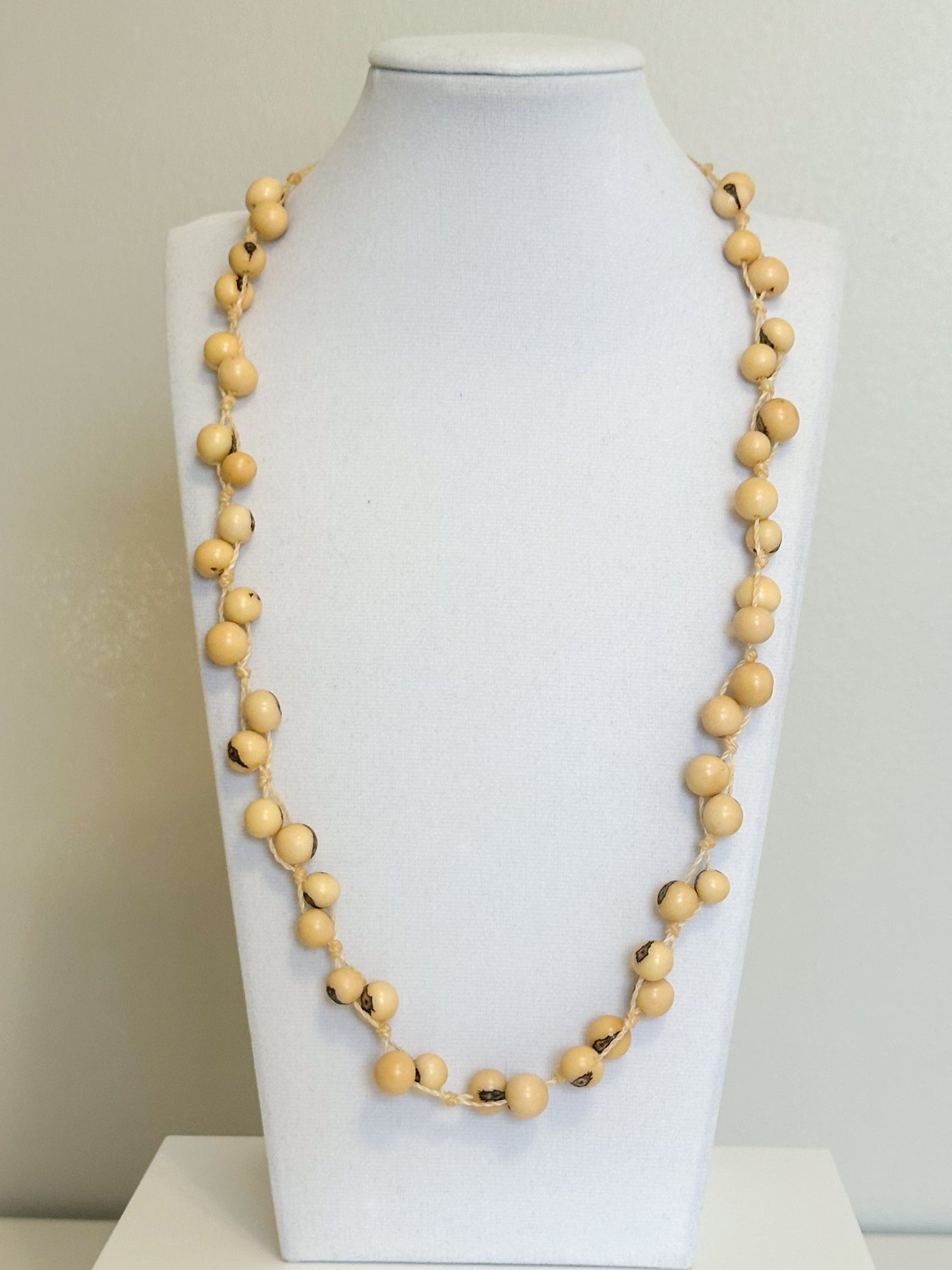 Beige açaí seed necklace made from polished Amazon seeds.