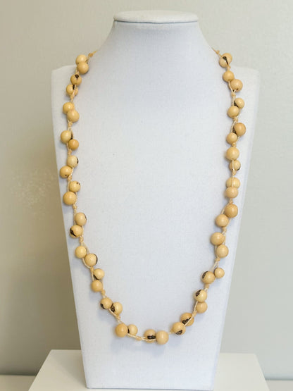Beige açaí seed necklace made from polished Amazon seeds.