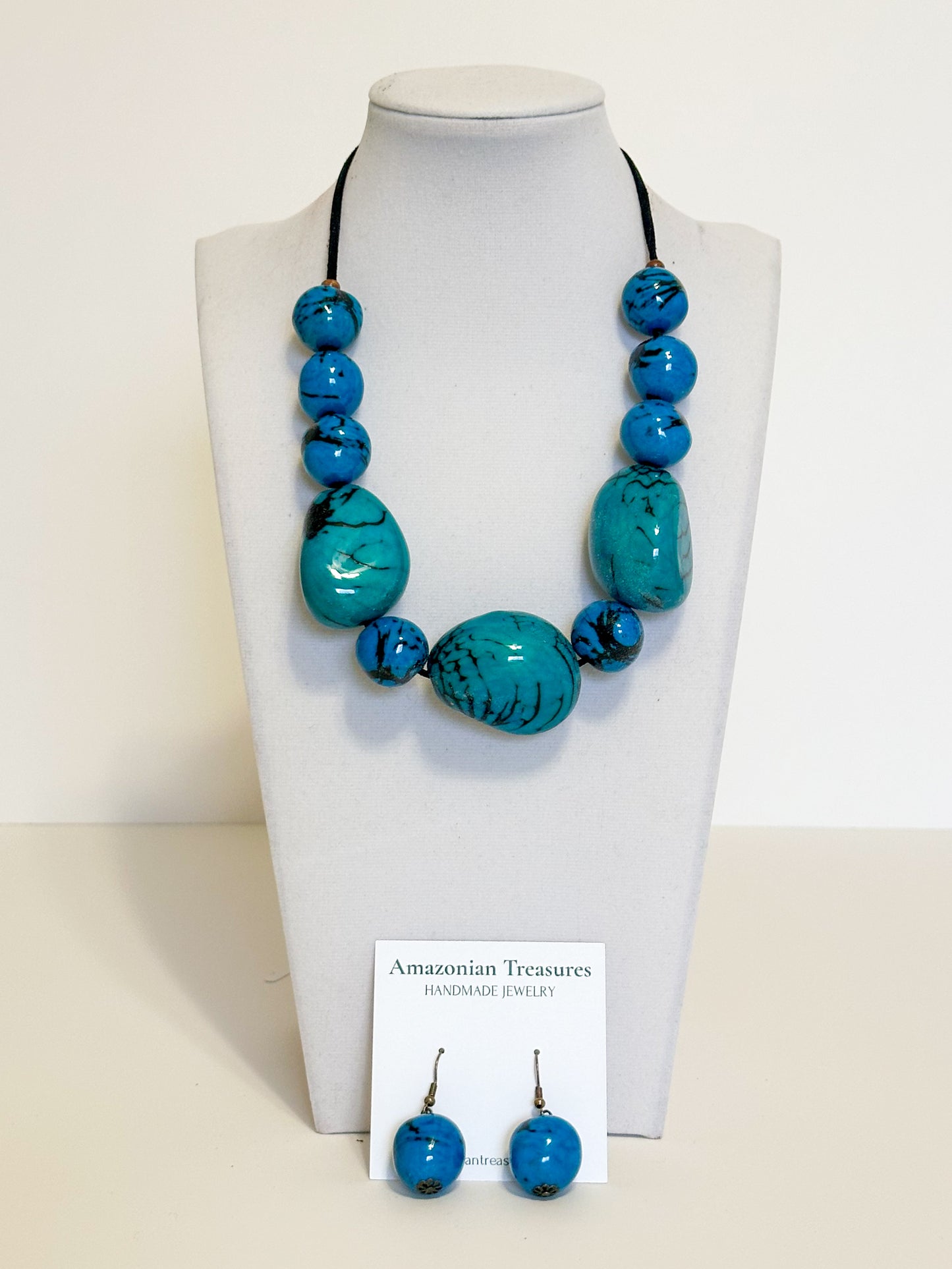 Blue jarina seed necklace and earrings handcrafted with vegetable ivory.