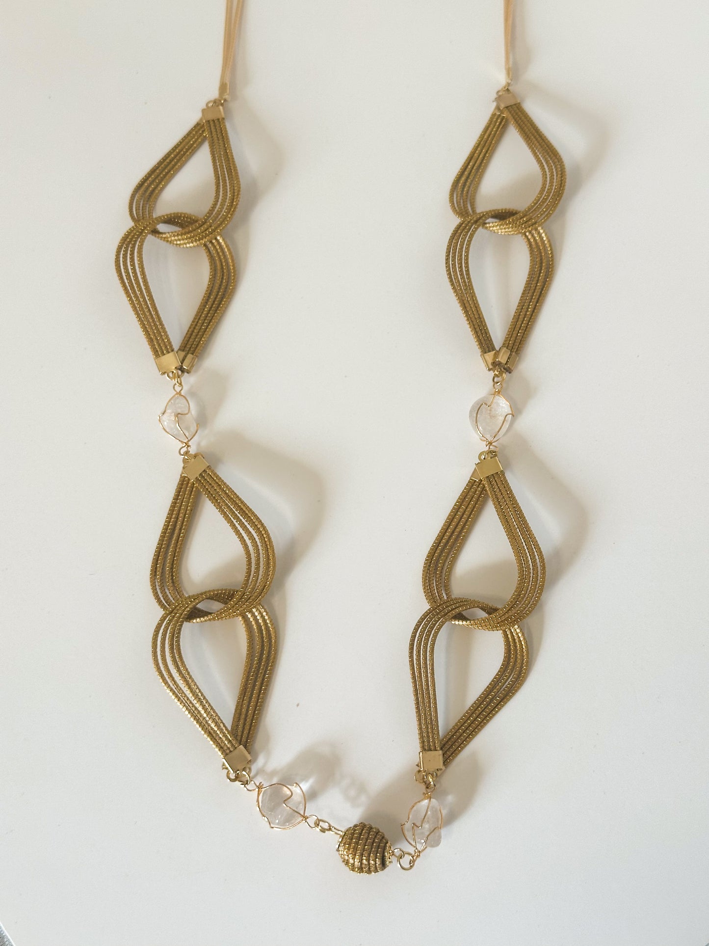 Capim dourado necklace with white gemstone handcrafted by quilombola artisans.