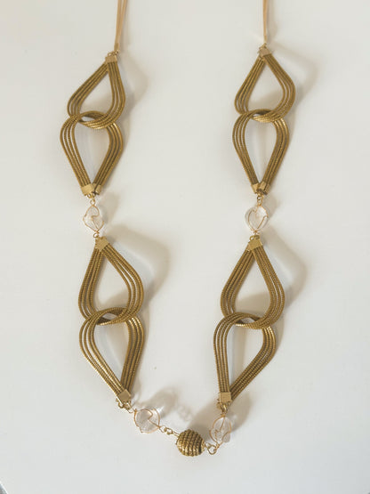 Capim dourado necklace with white gemstone handcrafted by quilombola artisans.