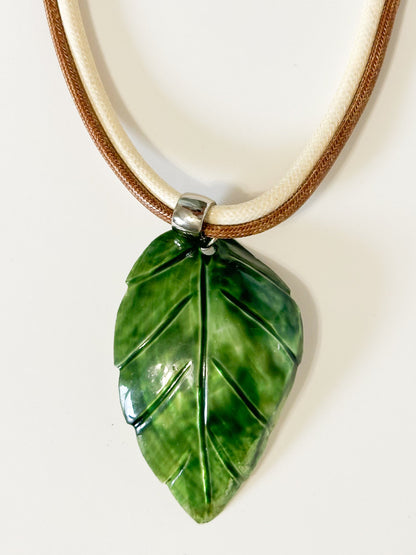 Carved mother of pearl leaf pendant from Amazon river shell detail