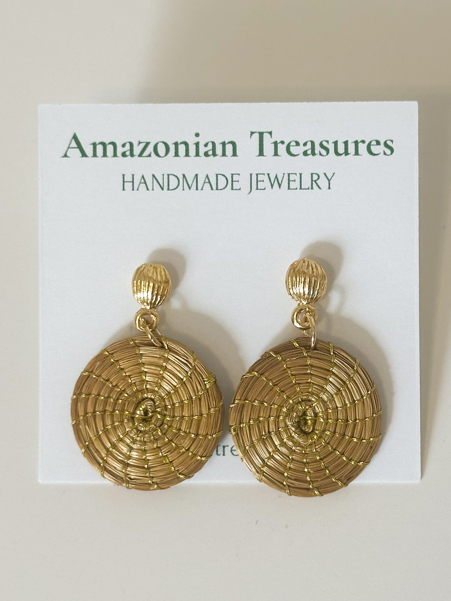 Circle of Life golden grass disc earrings handcrafted by quilombola artisans.