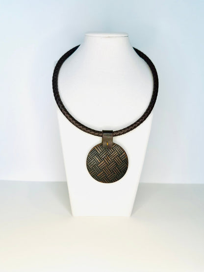 Reclaimed Amazon wood pendant necklace on display