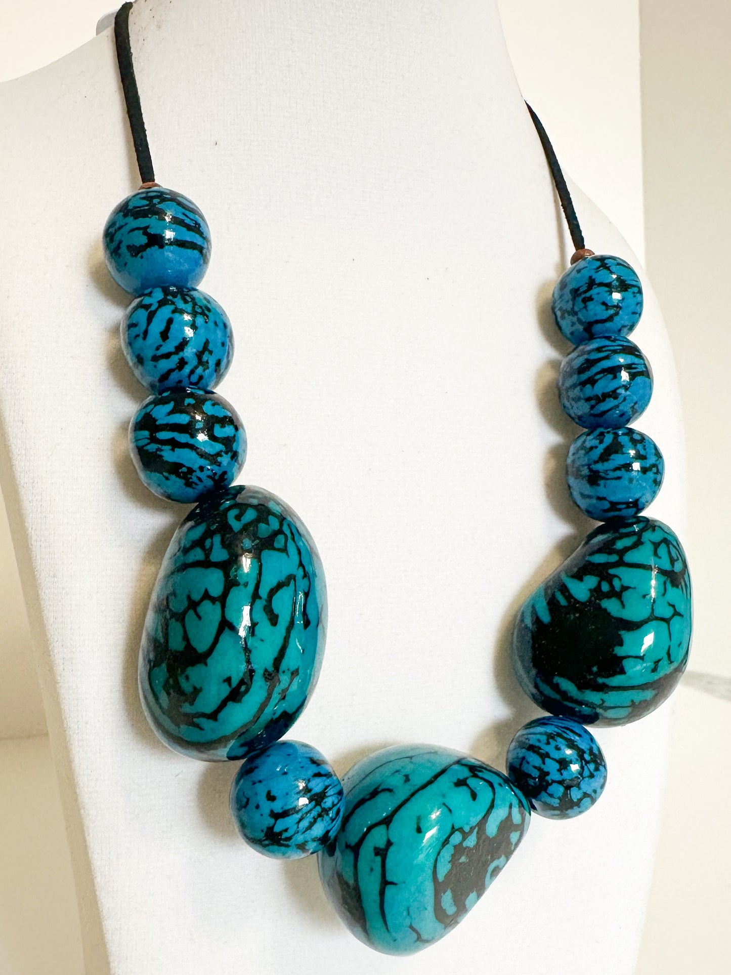 Close-up Blue jarina seed necklace handcrafted with vegetable ivory.
