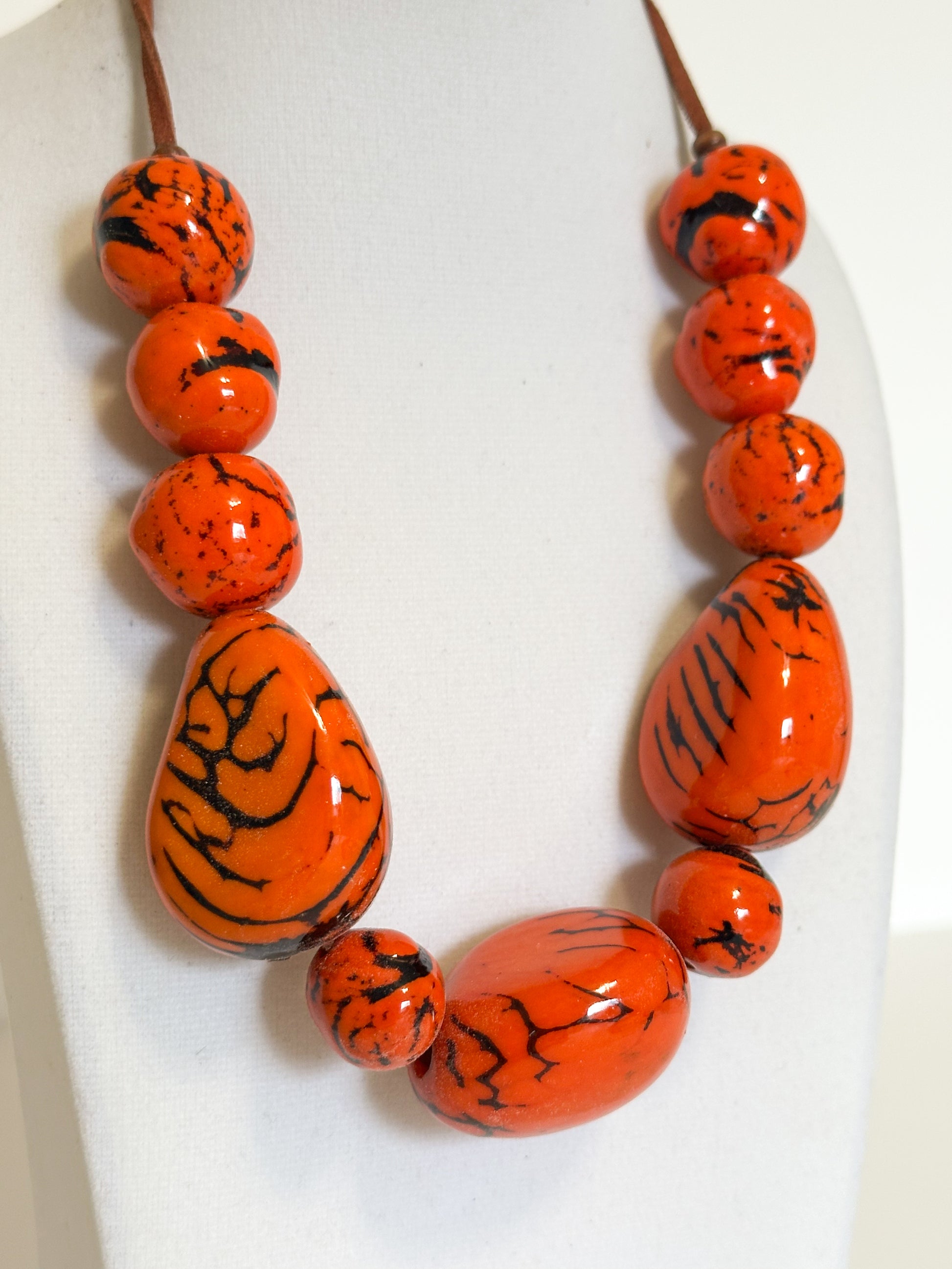 Close-up Orange dyed jarina bead necklace made by Brazilian artisan.