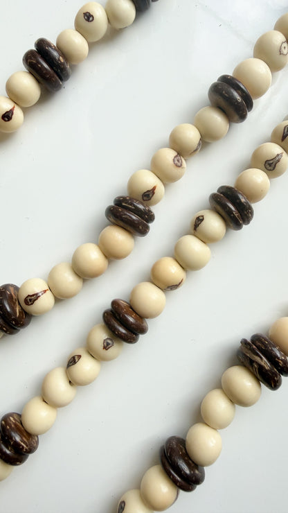 Close-up of Açaí seeds and coconut shell discs on handcrafted Brazilian necklace