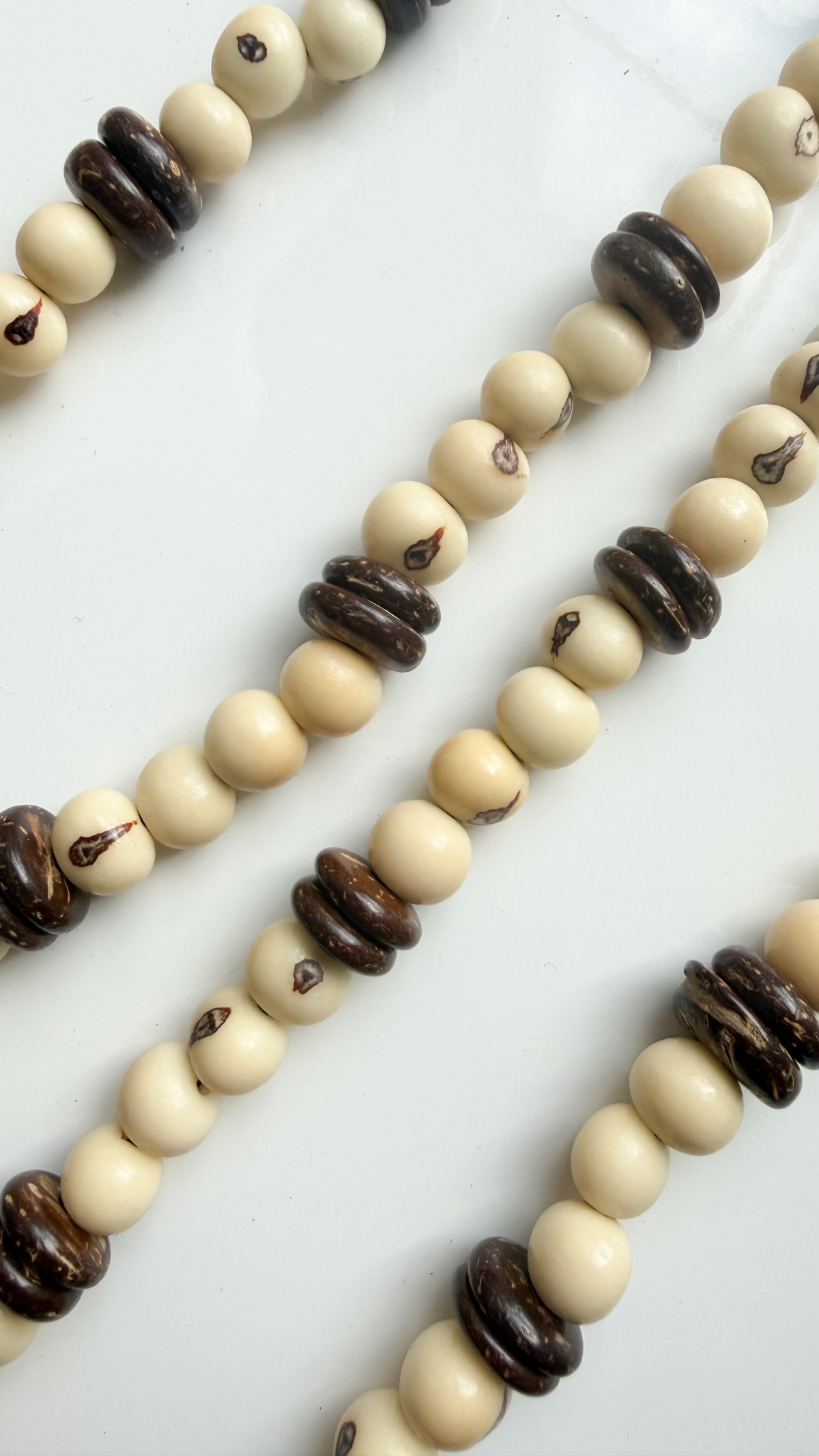 Close-up of Açaí seeds and coconut shell discs on handcrafted Brazilian necklace