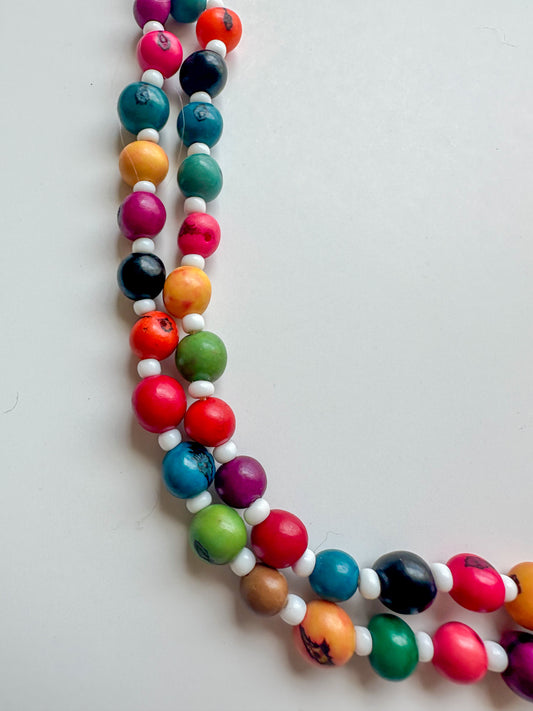 Close-up of colorful açaí seeds and white beads in handcrafted Amazon necklace