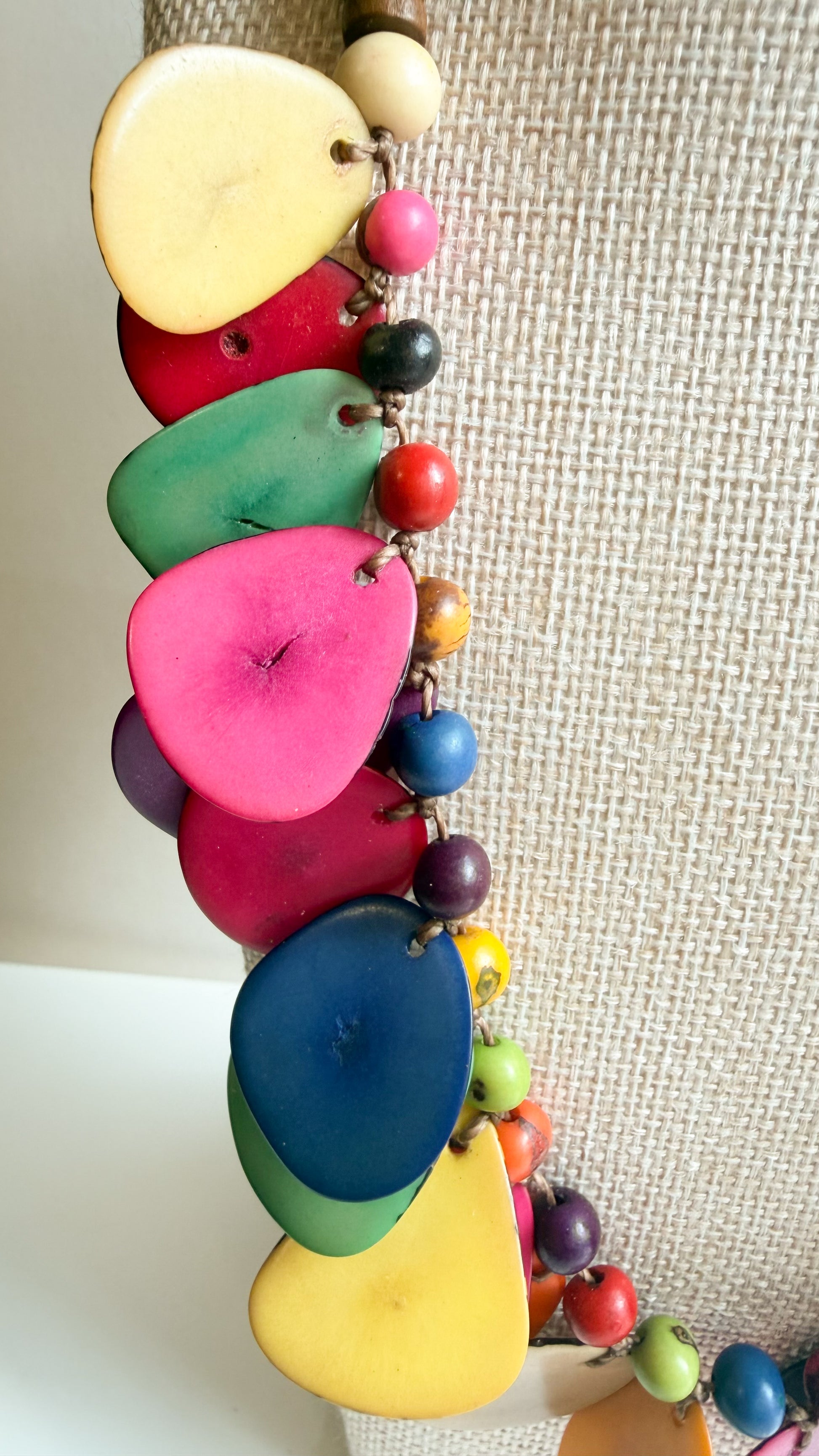 Close-up of colorful tinted Tagua vegetable ivory and Açaí seed necklace