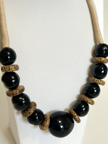 Close-up of jarina vegetable ivory beads with paxiúba and jupati seeds in handmade Amazon necklace.