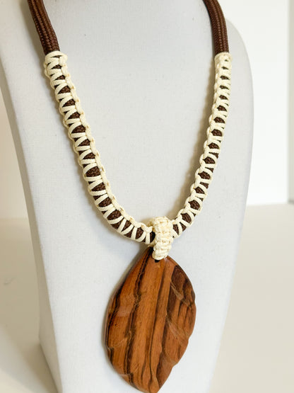 Close-up of muiracatiara wood leaf pendant showing natural grain patterns.