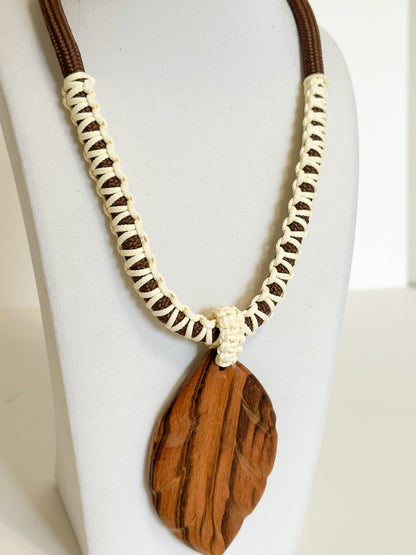 Close-up of muiracatiara wood leaf pendant showing natural grain patterns.