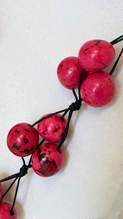 Close-up of pink Açaí seeds on handcrafted Brazilian necklace