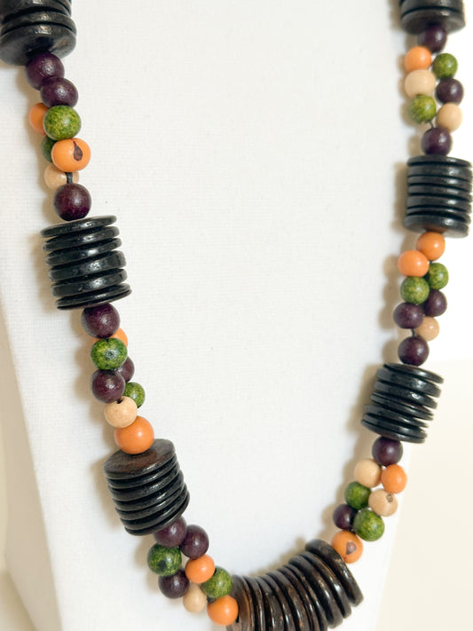 Close-up of polished açaí seeds and coconut beads in Brazilian artisan necklace.