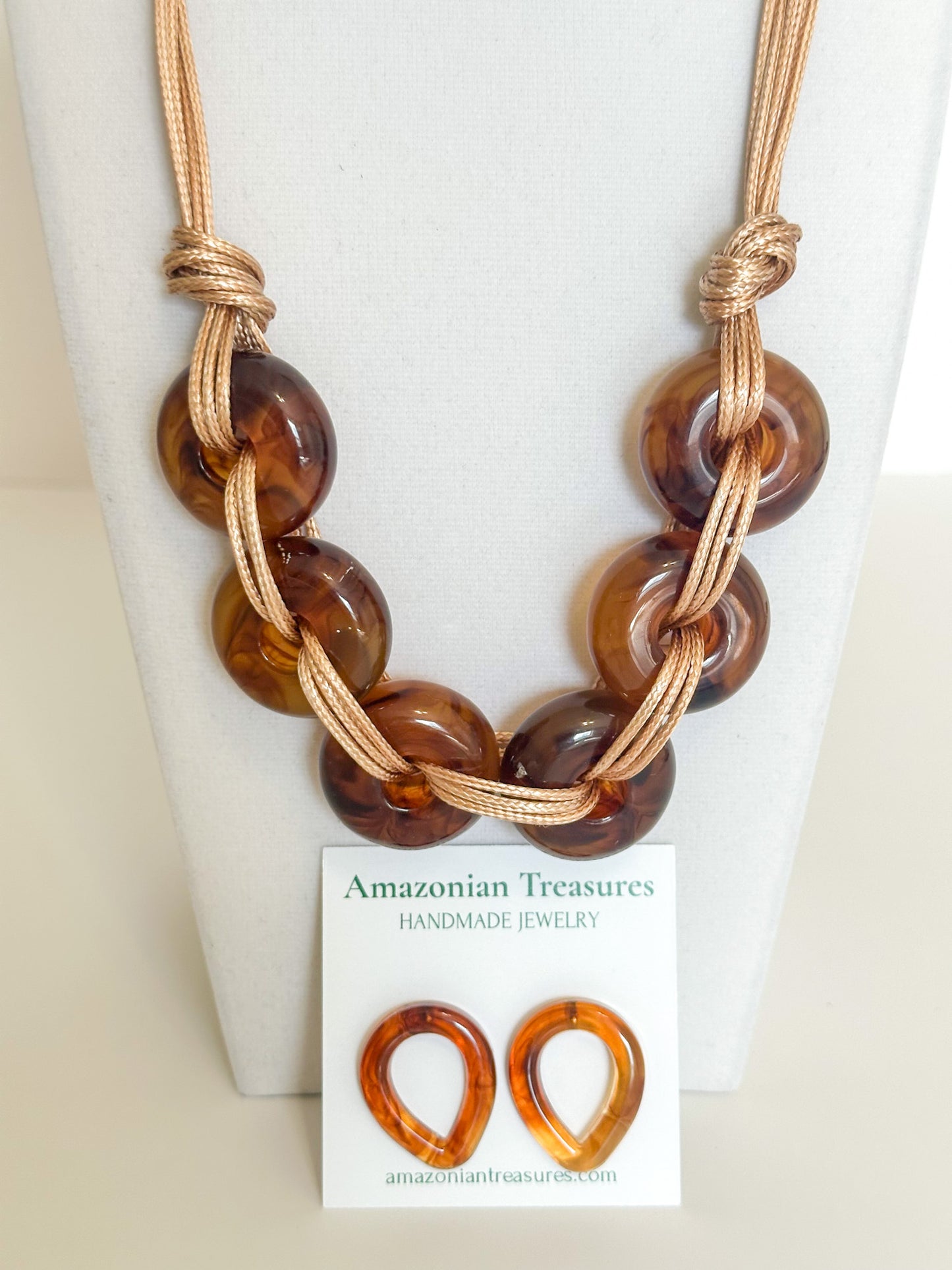 Close-up of resin chain links on cotton cord statement necklace.