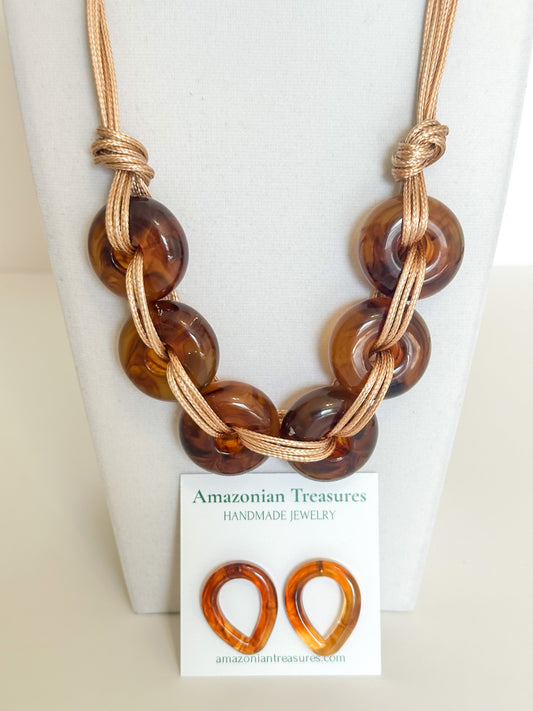 Close-up of resin chain links on cotton cord statement necklace.