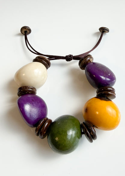 Colorful Jarina and coconut shell bracelet handmade by a Brazilian artisans association