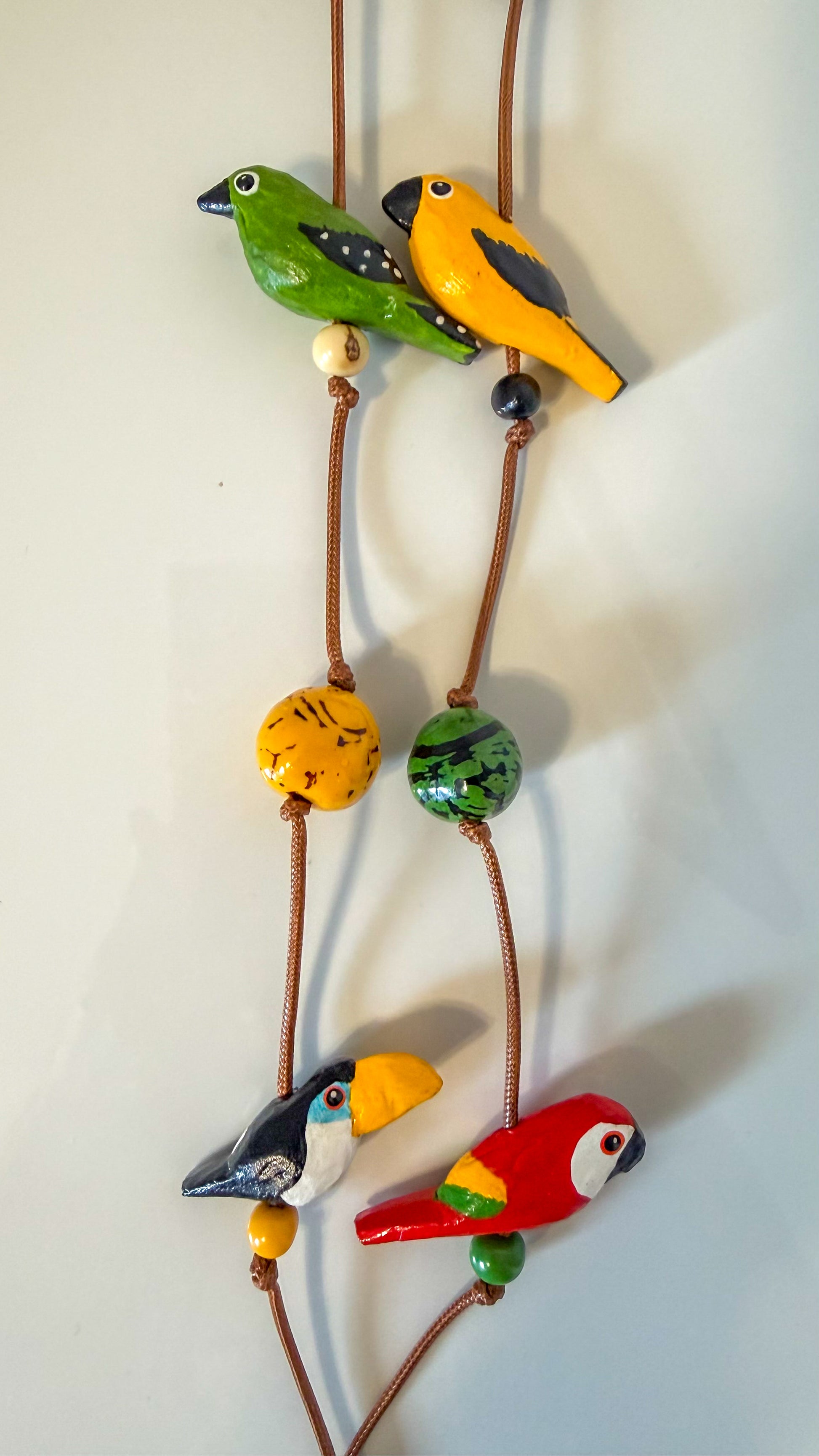 Colorful handcrafted Amazon bird shapes made from Buriti and Paxiúba