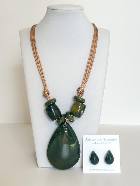 Cotton cord necklace with green resin drop pendant and matching resin earrings designed by a Brazilian jewelry studio.