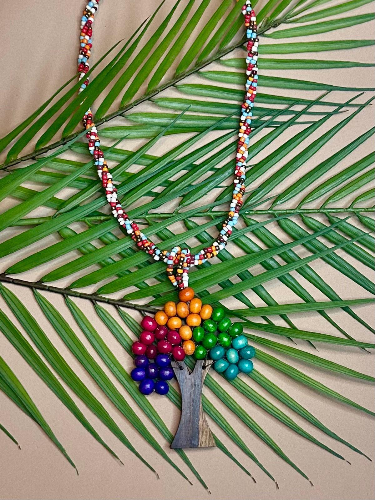 Eco handcrafted necklace made of colorful miçanga beads and natural wood.