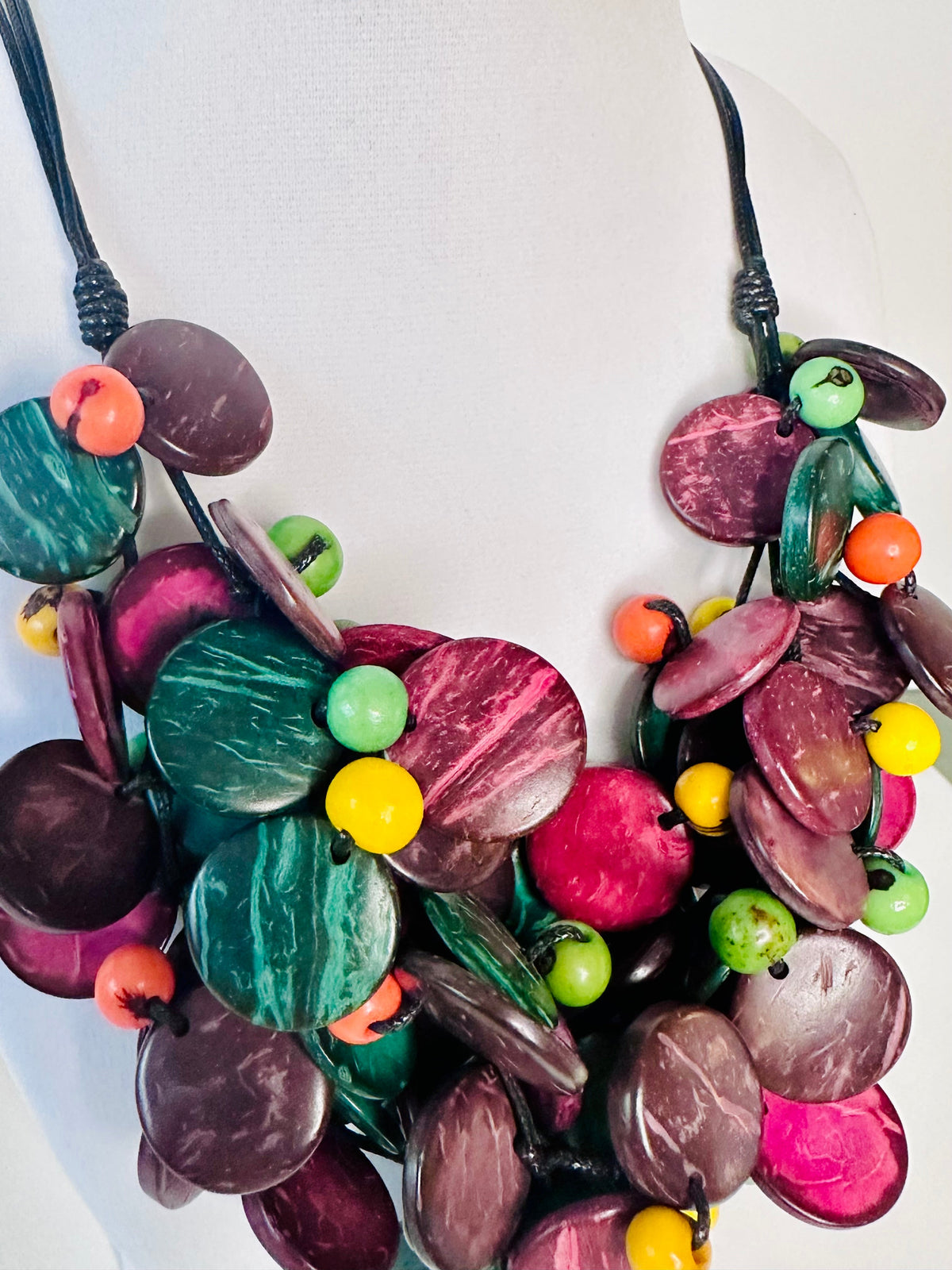 Vibrant açaí seed necklace detail with coconut fiber