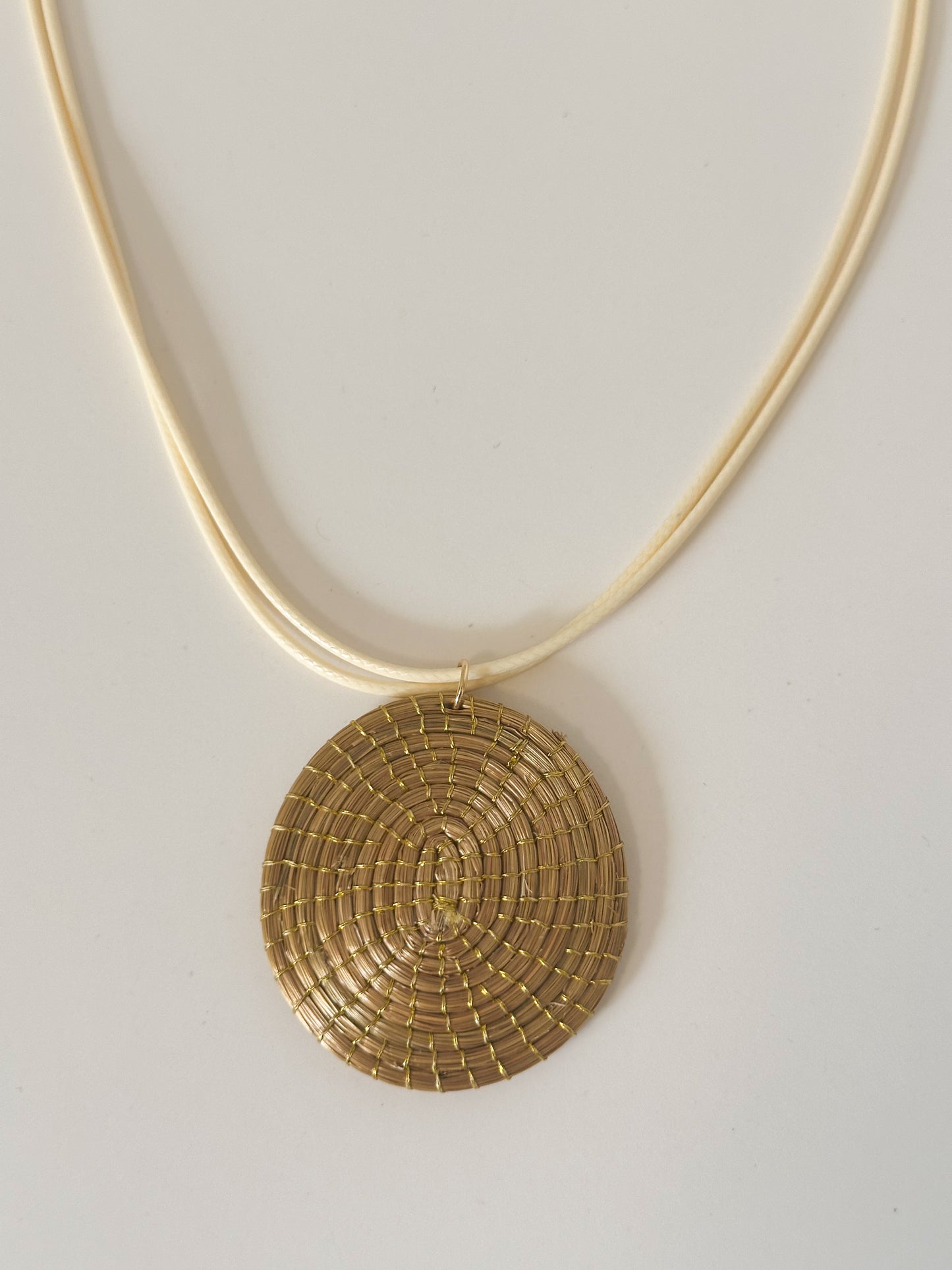 Golden Spiral capim dourado pendant necklace handcrafted with golden grass fibers.