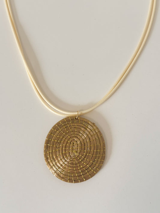 Golden Spiral capim dourado pendant necklace handcrafted with golden grass fibers.