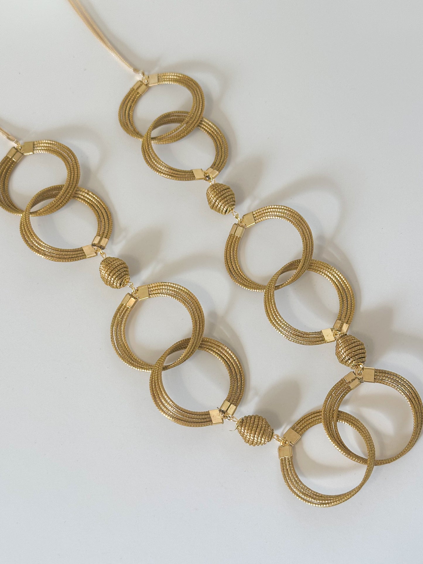Golden grass circle necklace with interlinked capim dourado rings handcrafted in Brazil.