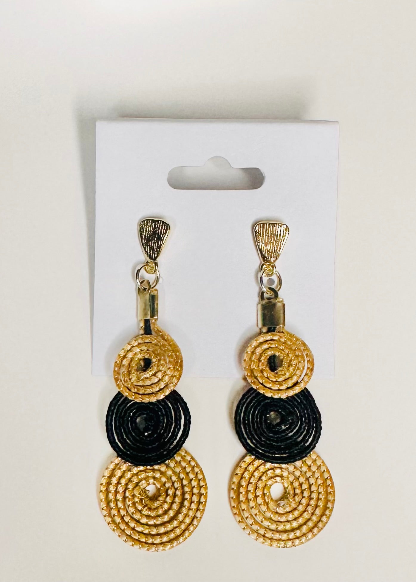 Golden grass earrings with dark accents crafted by Brazilian quilombola community