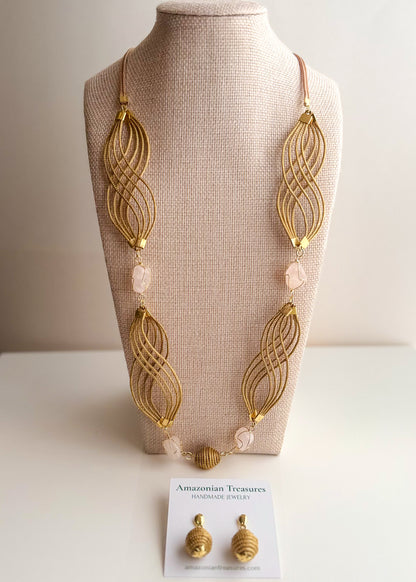 Golden grass flowing necklace with rose quartz gemstone handcrafted by quilombola artisans.