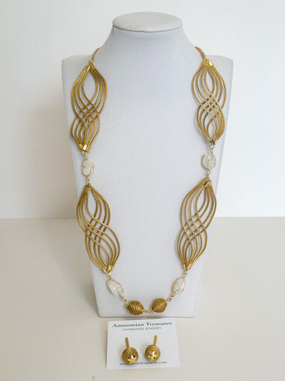 Golden grass flowing necklace with white gemstone handcrafted by quilombola artisans.