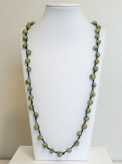 Green Açaí seed necklace handcrafted by an Indigenous Amazon community.
