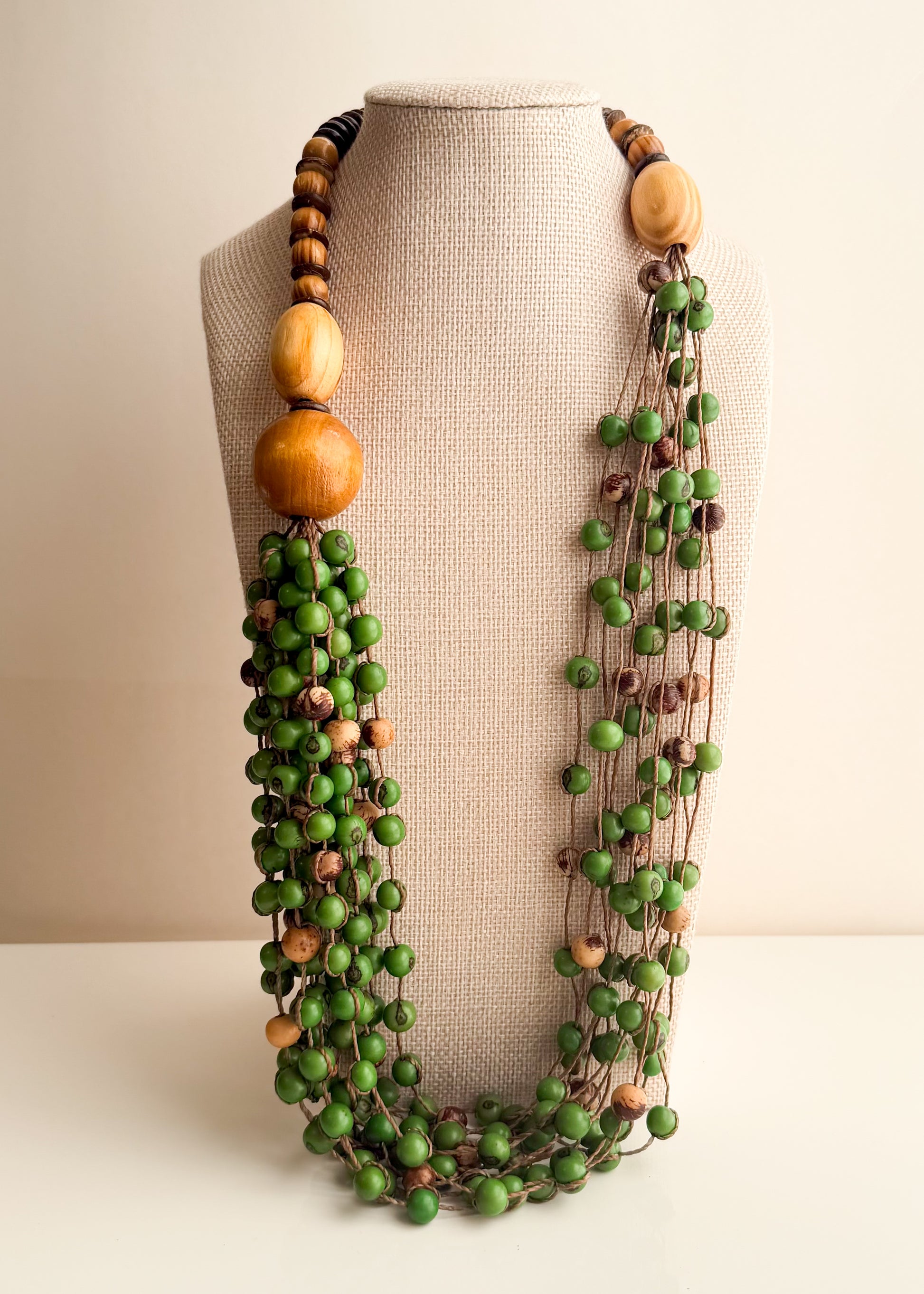 Green Açaí seed necklace with reclaimed wood and coconut shell handcrafted by Brazilian artisans