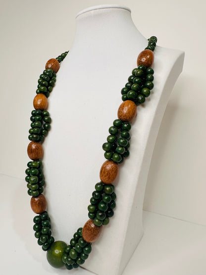 Green açaí seed and wood necklace handmade by Indigenous artisans