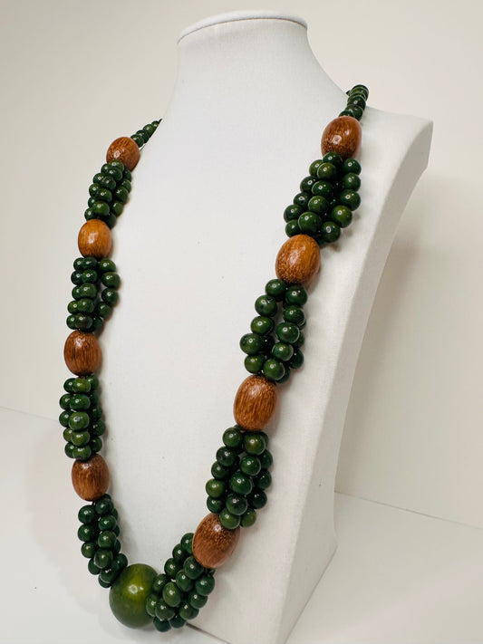 Green açaí seed and wood necklace handmade by Indigenous artisans